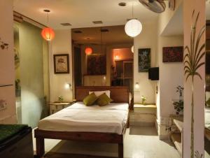 a bedroom with a large bed with two lamps at Dr Balis Bliss Homestay in New Delhi