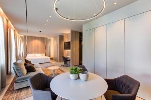 a living room with a table and chairs and a bed at Villa Italia in Cesenatico