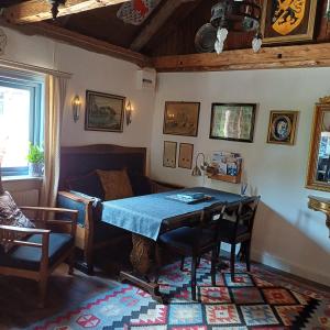 a living room with a table and a couch at Villagatan in Hjo +14 photos