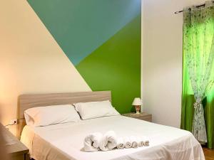 a bedroom with a bed with two towels on it at Casalhouse in Furci Siculo