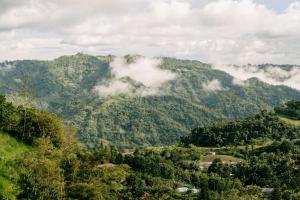 a view of a mountain with clouds on it at Grey Rock Mountain Cabin w/ Jacuzzi in Balamban