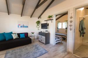 a living room with a couch and a television at Przylesie21 in Ustka