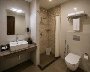 a bathroom with a sink and a toilet and a shower at Hotel S-mart In Delhi Airport & Free Airport Pickup in New Delhi +27 photos