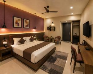 a hotel room with a bed and a desk and a room at Hotel S-mart In Delhi Airport & Free Airport Pickup in New Delhi