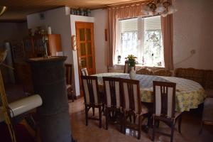 a dining room with a table and chairs and a window at Tiha Varoš in Varoš