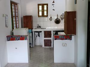 a kitchen with a sink and a counter top at Jambiani Holiday House in Jambiani