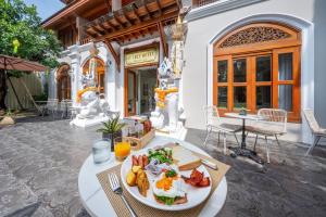 a plate of food on a table in front of a building at At Tree Hotel Thaphae Gate Chiangmai in Chiang Mai