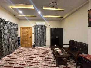 a living room with a couch and a table at Aone Hotel Quetta in Quetta