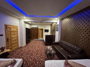 a living room with a couch and a blue light at Aone Hotel Quetta in Quetta