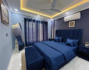 a blue bedroom with a blue bed and blue walls at Aone Hotel Quetta in Quetta