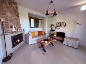 a living room with a couch and a fireplace at Noema Seaside in Dhaskalión