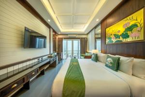 a bedroom with a large bed and a tv at At Tree Hotel Thaphae Gate Chiangmai in Chiang Mai