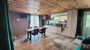 a kitchen and dining room with a table and chairs at Au Barthas in Caylus