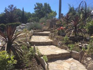 a garden with a stone path and plants at Au Barthas in Caylus