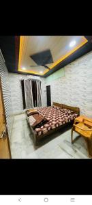 a bedroom with a large bed in a room at Paras guest house in Mathura