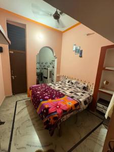 a bedroom with a bed and a large mirror at Arav Homestay in Rishīkesh
