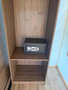 a radio sitting on a shelf in a cabinet at simami resort in Caldarola