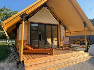 a gazebo with a porch and a chair at simami resort in Caldarola