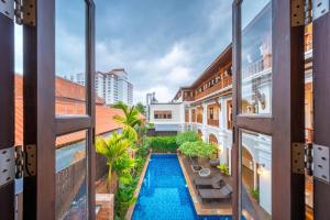 a view from the balcony of a building with a swimming pool at At Tree Hotel Thaphae Gate Chiangmai in Chiang Mai