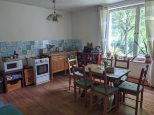 a kitchen with a table and chairs and a dining room at Herberge Vitopia in Magdeburg
