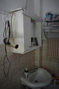 a bathroom with a sink and a hair dryer at Tiha Varoš in Varoš +42 photos