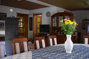 a vase filled with yellow flowers sitting on a table at Tiha Varoš in Varoš