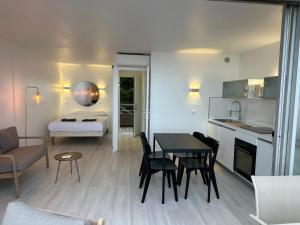 a kitchen and living room with a table and chairs at COSTA PLANA COLLECTION - Cap d'Ail - Monaco in Cap d'Ail
