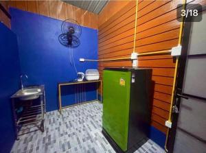 a bathroom with a green refrigerator and a sink at Lamai Home Koh Yao Noi in Ko Yao Noi