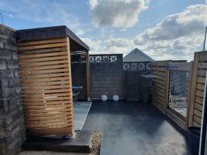 a backyard with a wooden privacy fence at Swiss Valley retreat in Trostre