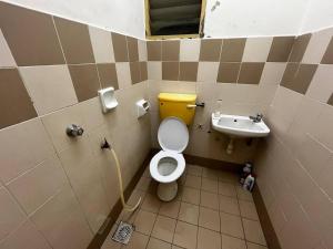 a bathroom with a toilet and a sink at Homestay Seri Aishah in Chemor +18 photos
