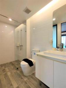 a bathroom with a toilet and a sink and a shower at Silom Studios in Bangkok +129 photos