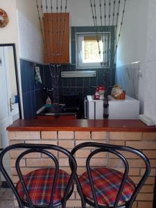 two chairs sitting at a counter in a kitchen at Dukii in Vrnjci