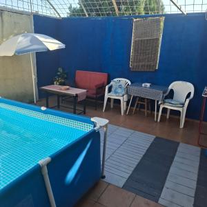a patio with a swimming pool and chairs and tables at Dukii in Vrnjci