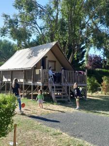 a group of children playing in front of a yurt at Camping Port la Vallée in Saint-Mathurin