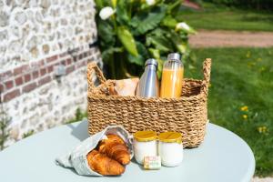 a basket of food and drinks and croissants on a table at Les Sept Logias in Les Loges