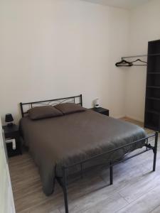 a bedroom with a bed with a black metal frame at Gîte Le 500 in Mayres +14 photos