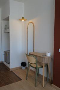 a table and a chair in a room at โรงแรมเดย์โฮเต็ล in Khon Kaen