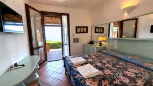 a bedroom with a bed and a bathroom with a sink at Hotel Capo Sud in Lacona +126 photos