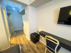 a room with a chair and a desk with a television at Fethibey Otel in Bartın +18 photos