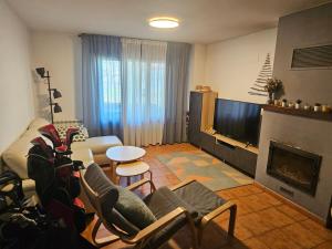 a living room with a couch and a fireplace at Villa Sojuela Green in Sojuela