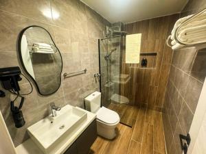 a bathroom with a toilet and a sink and a shower at Fethibey Otel in Bartın