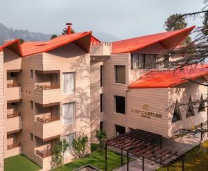 an apartment building with an orange roof at Hotel Arif Castle, Nainital in Nainital