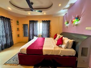 a bedroom with a large bed with pink walls at Heritage Waves in Puri
