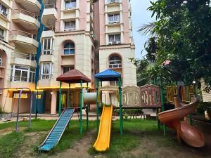 a playground in front of a building at Heritage Waves in Puri