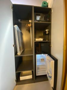 a small refrigerator in a kitchen with its door open at Private Room-1 in Miami