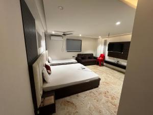 a hotel room with a bed and a couch at Bodhi international in Gaya