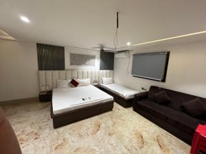 a living room with a bed and a couch at Bodhi international in Gaya