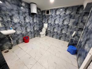 a bathroom with a toilet and a sink at Bodhi international in Gaya
