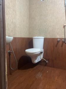 a bathroom with a toilet and a sink at Coliveinn in Ernakulam