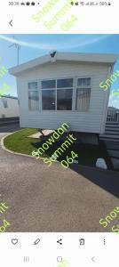a picture of a house with a sign in front of it at Snowdon summit 064 in Barmouth +2 photos